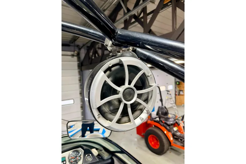 Slide: The Image of Open storage compartment in 2012 Moomba Mojo 2.5 boat, featuring blue and gray upholstery. - 13