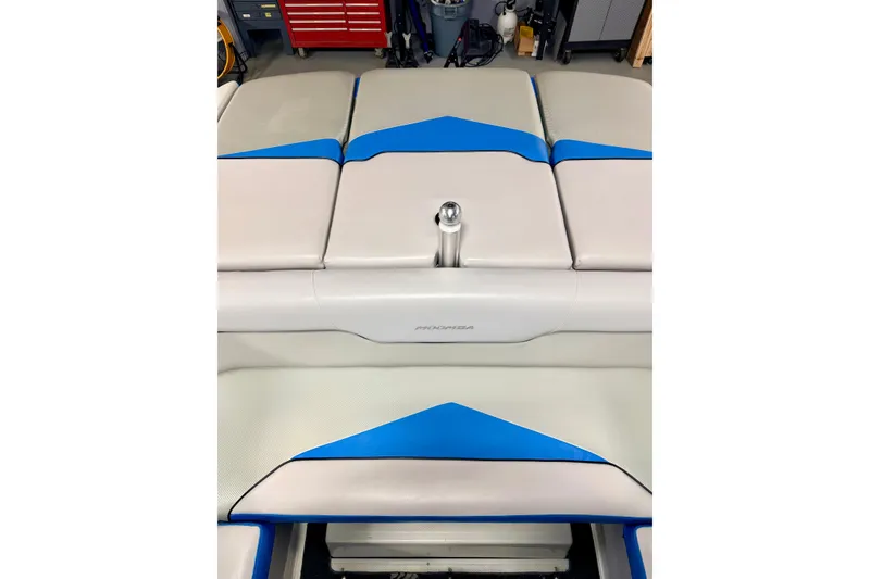 Slide: The Image of 2012 Moomba Mojo 2.5 boat interior with blue and white seating. - 20