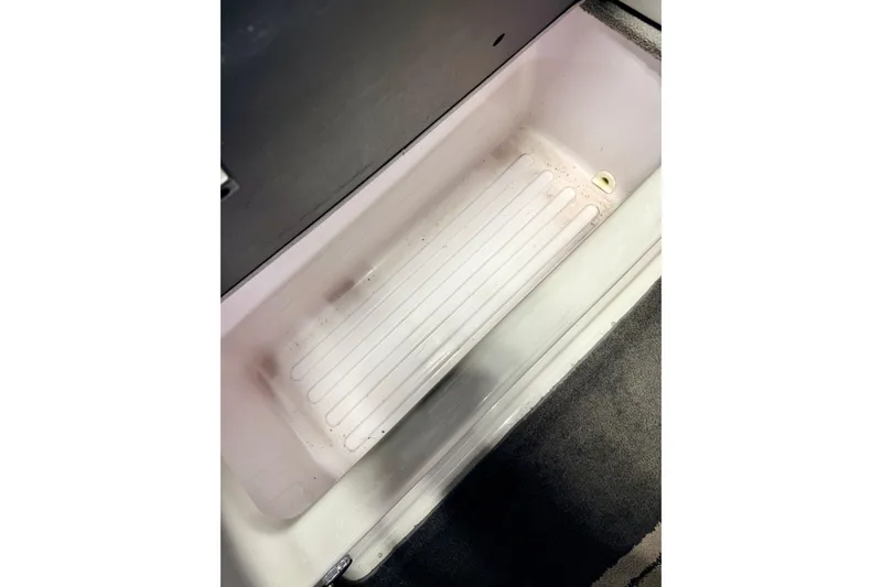 Slide: The Image of Interior of a 2012 Moomba Mojo 2.5 boat, featuring sleek seating and carpet. - 22