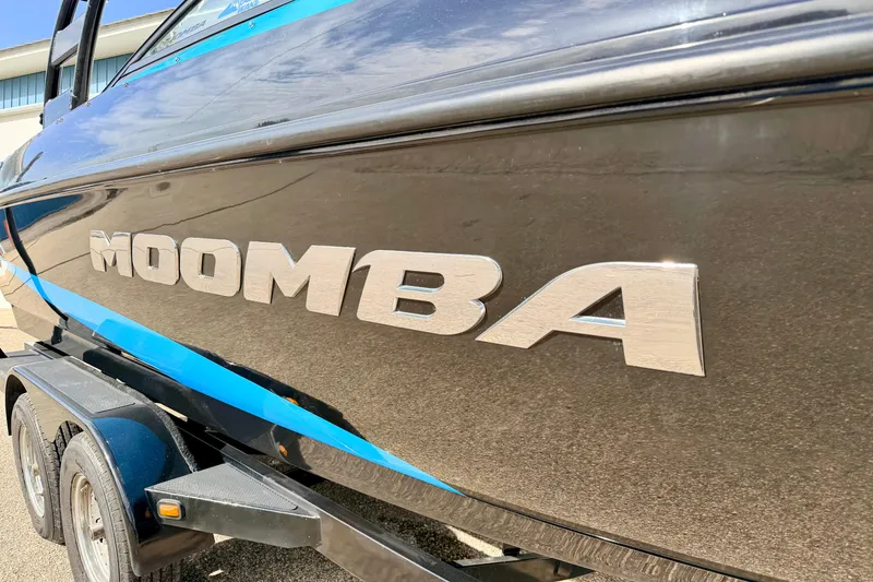 Slide: The Image of 2012 Moomba Mojo 2.5 boat with blue accents on a trailer. - 4