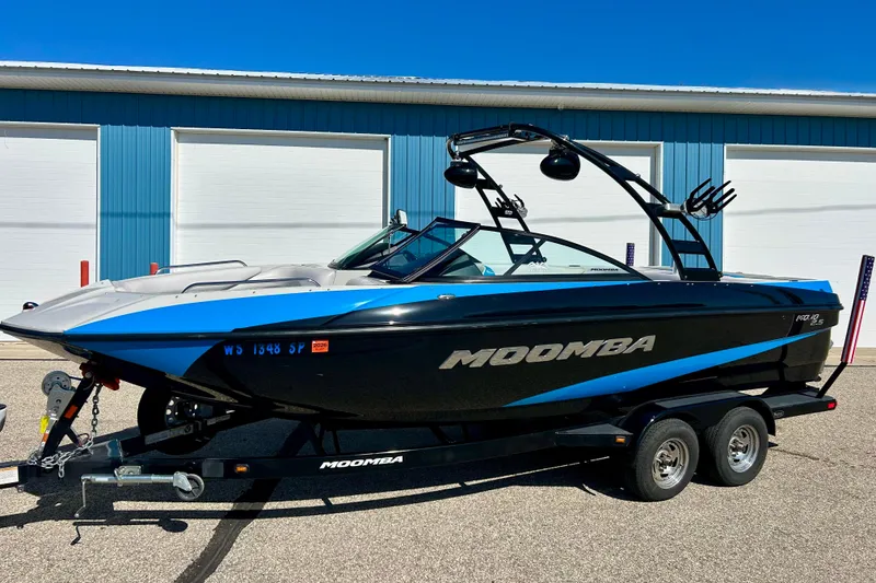 Slide: The Image of 2012 Moomba Mojo 2.5 boat on trailer, parked outside blue garage. - 42