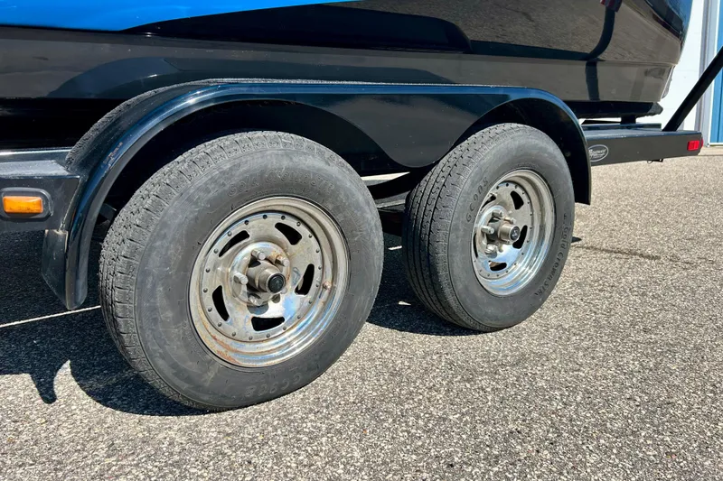 Slide: The Image of 2012 Moomba Mojo 2.5 boat on trailer, black and blue design, Wisconsin registration. - 44