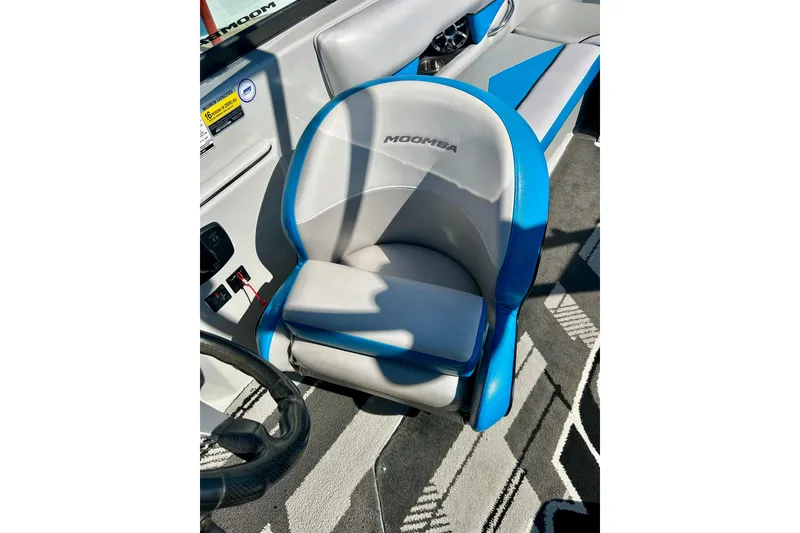 Slide: The Image of Captain's seat of 2012 Moomba Mojo 2.5 boat, featuring blue and gray upholstery. - 51