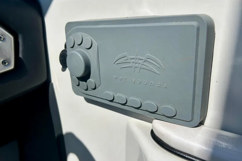 Slide: The Image of 2012 Moomba Mojo 2.5 boat interior with blue and gray seating, steering wheel, and dashboard. - 58