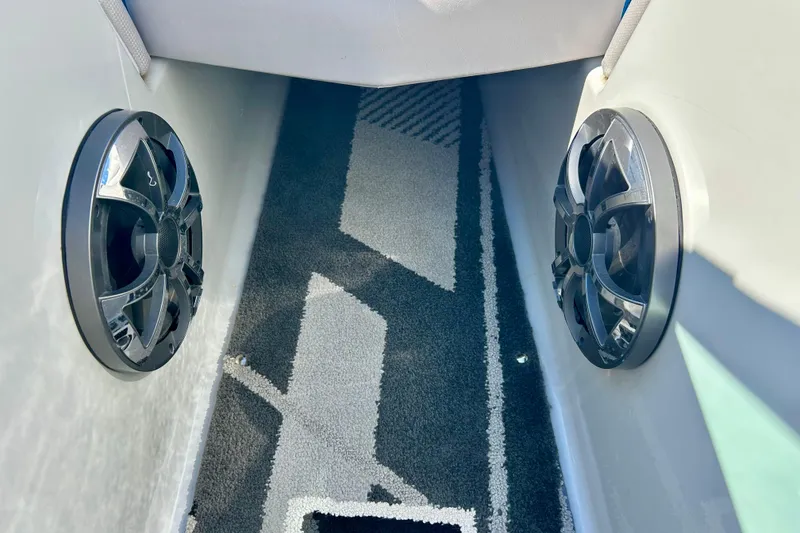 Slide: The Image of 2012 Moomba Mojo 2.5 boat interior with dual cup holders and carpeted flooring. - 62