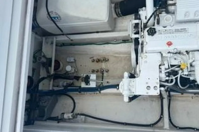 Slide: The Image of Engine compartment of a 2019 OceanPro 35 boat, showcasing mechanical components and wiring. - 11