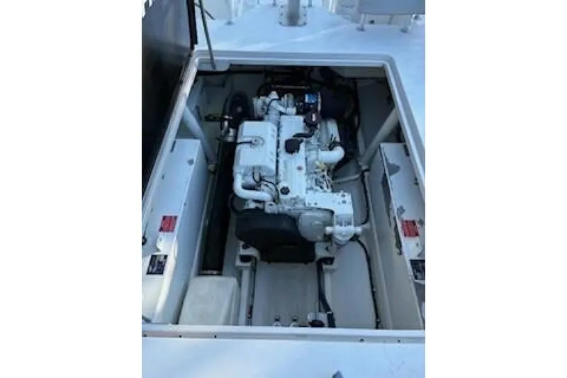 Slide: The Image of Engine compartment of a 2019 OceanPro 35 boat, showcasing the engine and surrounding components. - 2