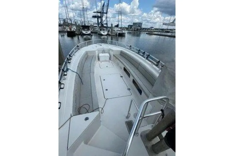 Slide: The Image of 2019 OceanPro 35 boat docked at marina, featuring spacious deck and seating. - 3