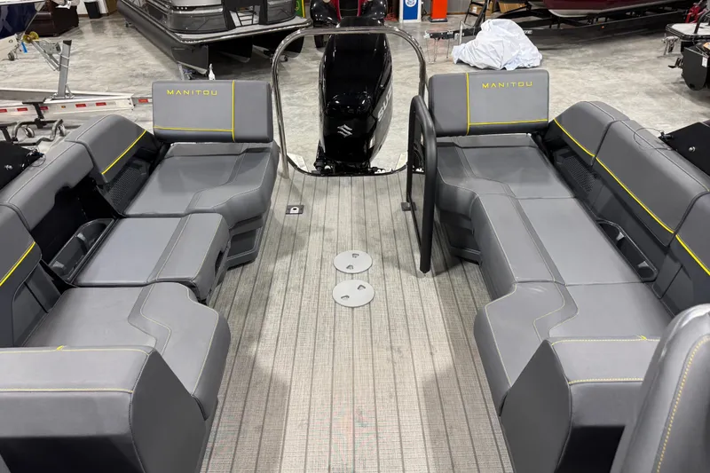 Slide: The Image of 2025 Manitou 24 Explore pontoon boat interior with gray seating and modern design. - 12