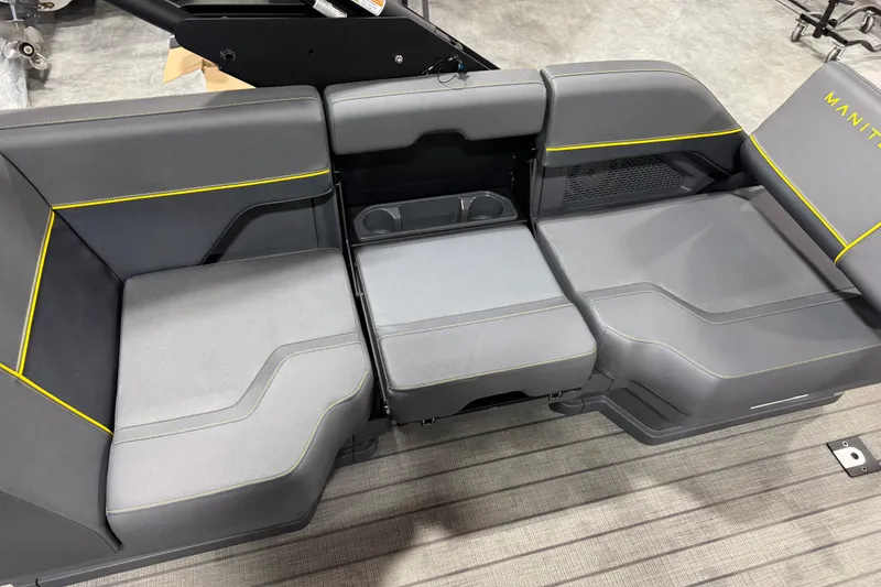 Slide: The Image of 2025 Manitou 24 Explore boat seating with gray upholstery and yellow accents. - 13