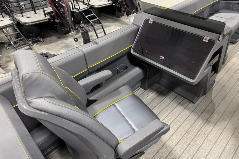 Slide: The Image of 2025 Manitou 24 Explore boat interior with sleek seating and modern design. - 8