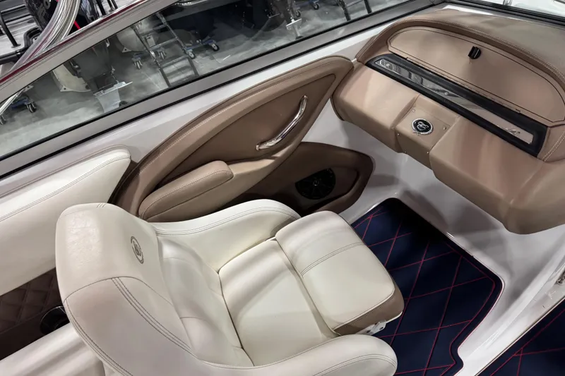 Slide: The Image of Interior of a 2012 Cobalt 242 boat with beige and white seating. - 10