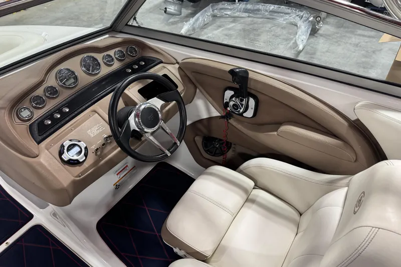 Slide: The Image of 2012 Cobalt 242 boat interior with steering wheel and dashboard controls. - 11