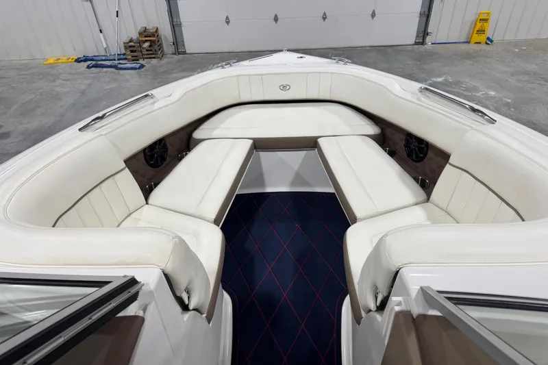 Slide: The Image of Interior of 2012 Cobalt 242 boat with white seating and blue carpet. - 12