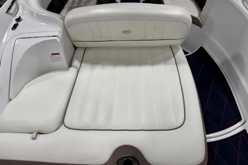 Slide: The Image of 2012 Cobalt 242 boat interior with white leather seating and sleek design. - 6