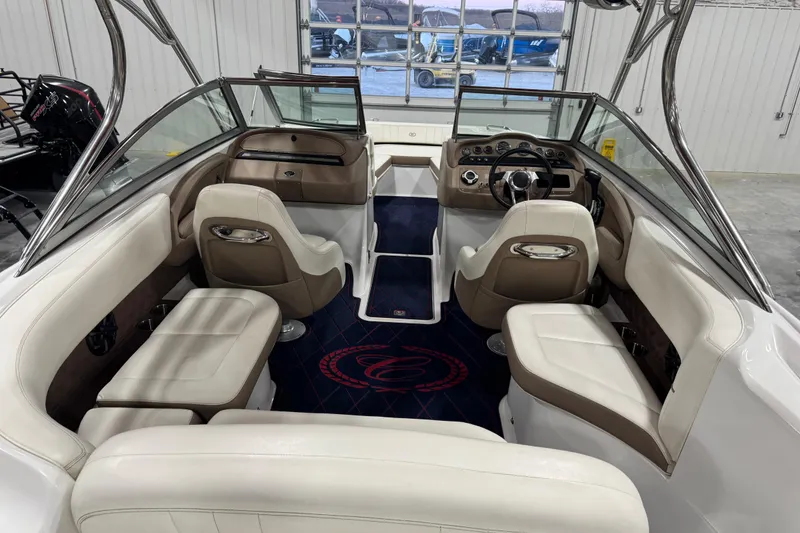 Slide: The Image of Interior of a 2012 Cobalt 242 boat with luxurious seating and modern dashboard. - 7