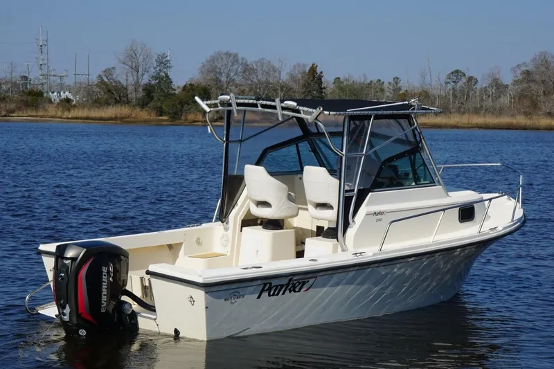 Slide: The Image of 1996 Parker 2110 boat on calm water with Evinrude outboard motor. - 7