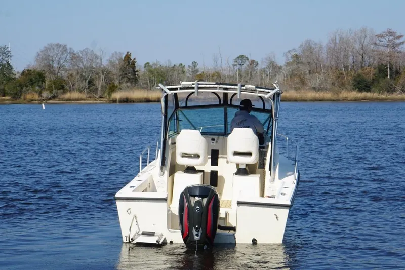 Slide: The Image of Boat on water, Parker 2110 model, 1996, with outboard motor, scenic background. - 8
