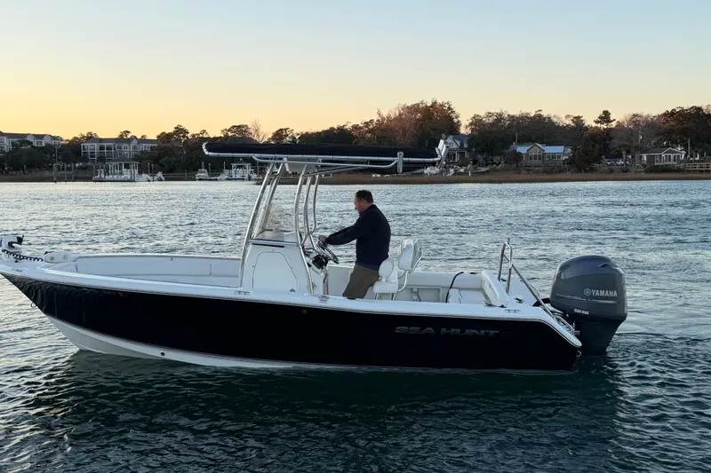 Slide: The Image of 2014 Sea Hunt Ultra 211 boat on water at sunset, with Yamaha engine. - 17