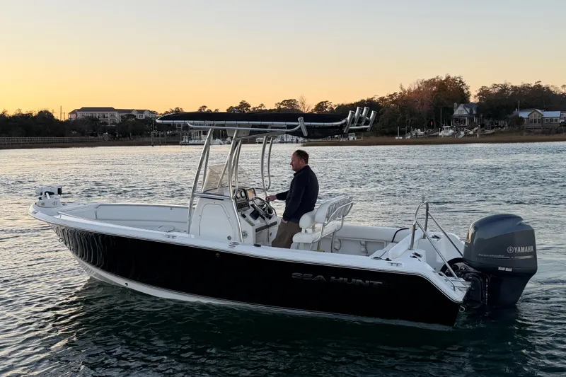 Slide: The Image of 2014 Sea Hunt Ultra 211 boat on water at sunset, featuring Yamaha outboard motor. - 18