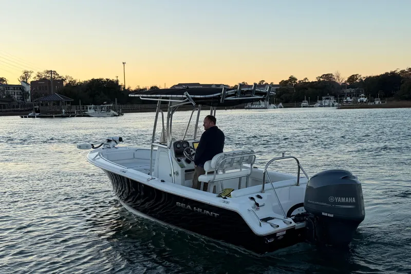 Slide: The Image of 2014 Sea Hunt Ultra 211 boat on water at sunset, with Yamaha engine. - 20