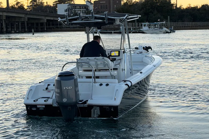 Slide: The Image of 2014 Sea Hunt Ultra 211 boat on water, rear view with Yamaha engine. - 22