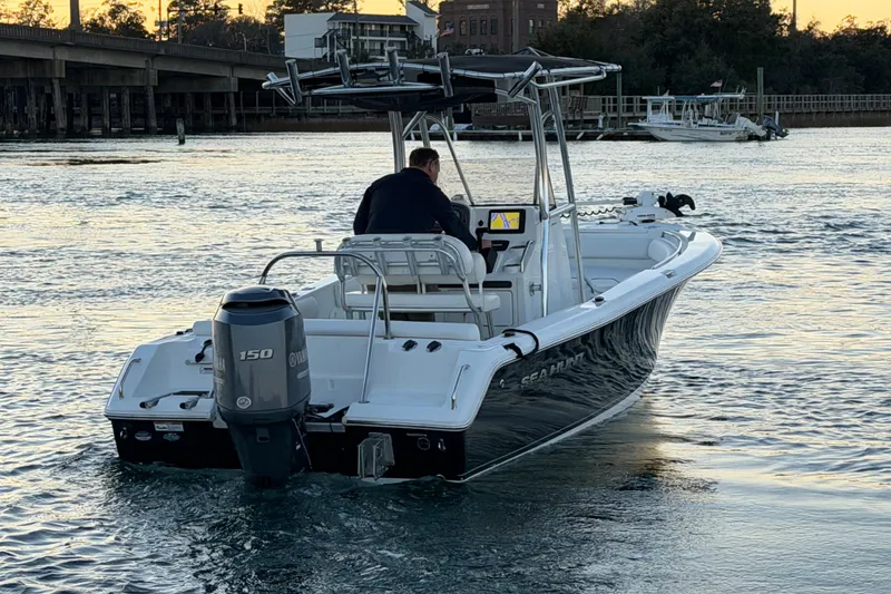 Slide: The Image of 2014 Sea Hunt Ultra 211 boat on water, rear view with Yamaha 150 engine. - 23