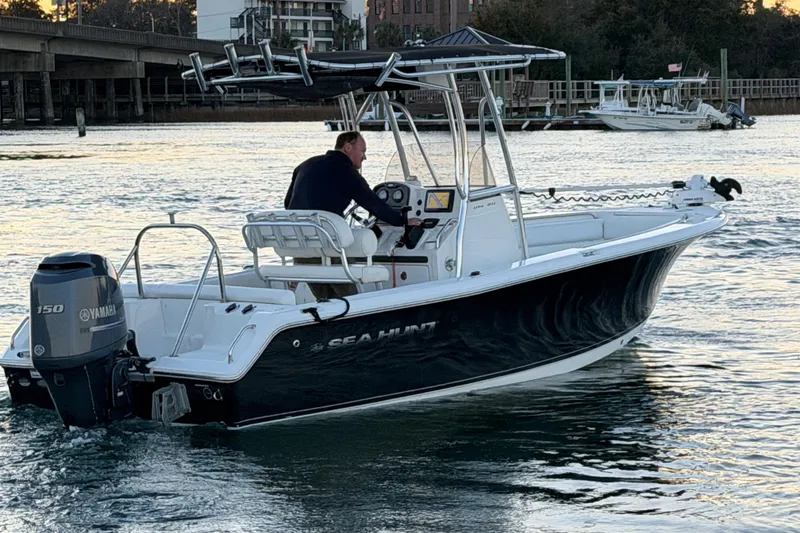 Slide: The Image of 2014 Sea Hunt Ultra 211 boat on water, featuring Yamaha 150 engine. - 25