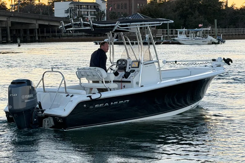Slide: The Image of 2014 Sea Hunt Ultra 211 boat on water, featuring Yamaha 150 engine, scenic background. - 26