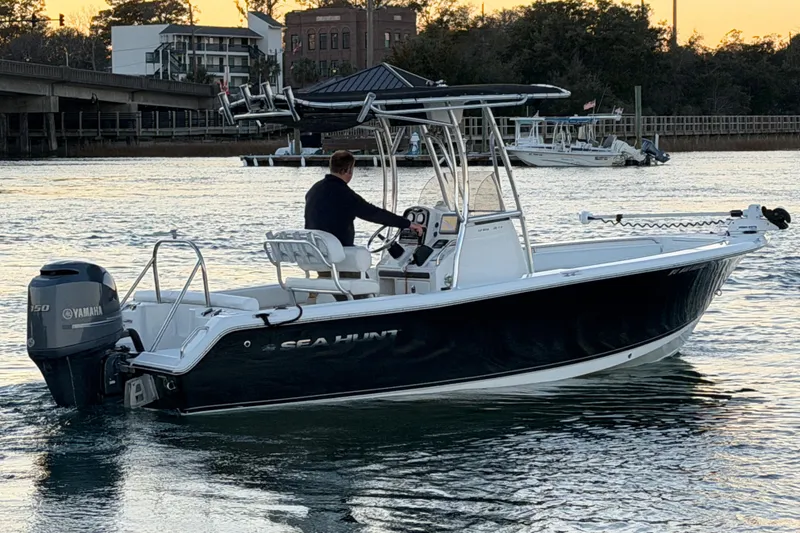 Slide: The Image of 2014 Sea Hunt Ultra 211 boat with Yamaha engine on calm water at sunset. - 27