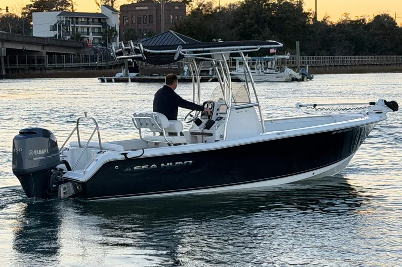 Slide: The Image of 2014 Sea Hunt Ultra 211 boat on water at sunset, featuring Yamaha outboard motor. - 28