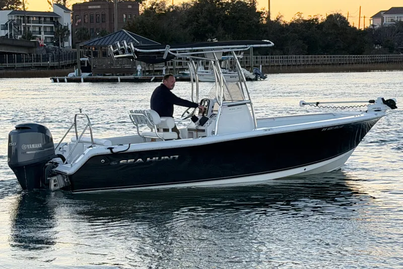 Slide: The Image of 2014 Sea Hunt Ultra 211 boat on water at sunset, with Yamaha engine. - 29