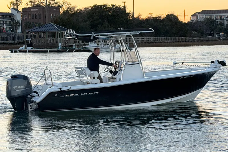 Slide: The Image of 2014 Sea Hunt Ultra 211 boat on water at sunset with Yamaha engine. - 30