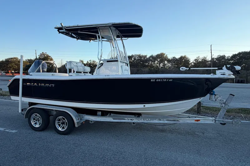 Slide: The Image of 2014 Sea Hunt Ultra 211 boat on trailer, parked outdoors. - 32