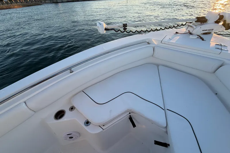 Slide: The Image of 2014 Sea Hunt Ultra 211 boat interior with white seating and Minn Kota trolling motor. - 35