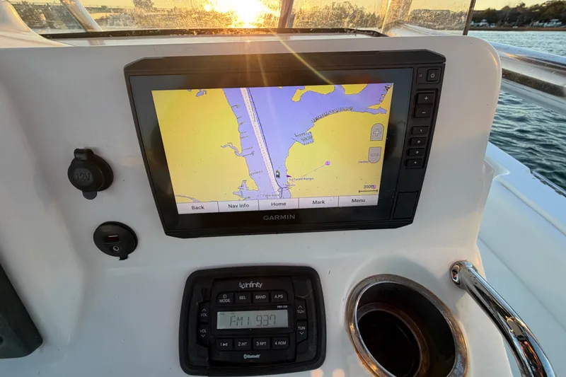 Slide: The Image of 2014 Sea Hunt Ultra 211 boat dashboard with Garmin navigation system at sunset. - 45