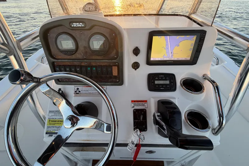 Slide: The Image of 2014 Sea Hunt Ultra 211 boat dashboard with steering wheel and navigation system. - 46