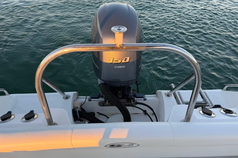 Slide: The Image of 2014 Sea Hunt Ultra 211 boat with Yamaha 150 engine on calm water. - 49