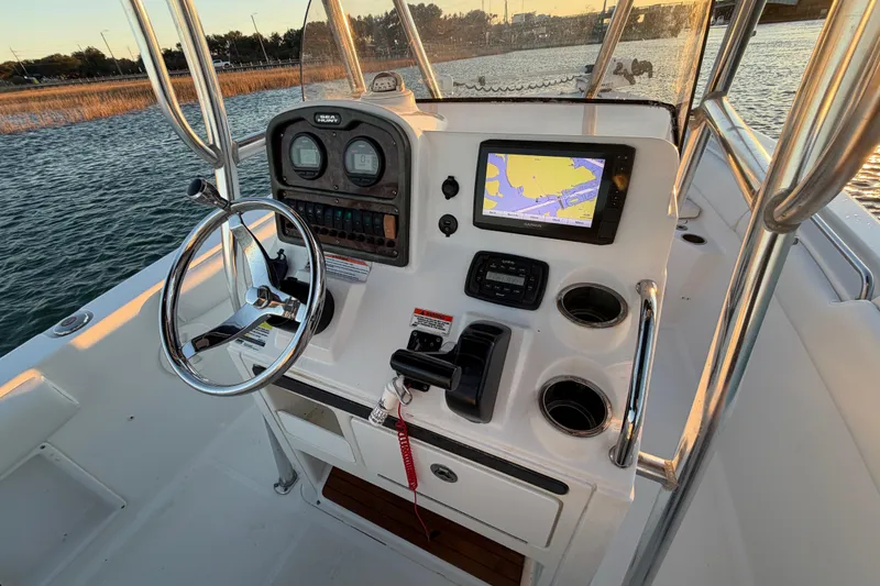 Slide: The Image of 2014 Sea Hunt Ultra 211 boat console with steering wheel and navigation system. - 51