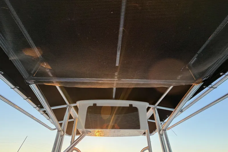 Slide: The Image of 2014 Sea Hunt Ultra 211 boat canopy with sunlight filtering through. - 56