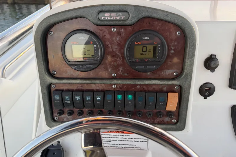 Slide: The Image of 2014 Sea Hunt Ultra 211 dashboard with Yamaha gauges and control switches. - 57