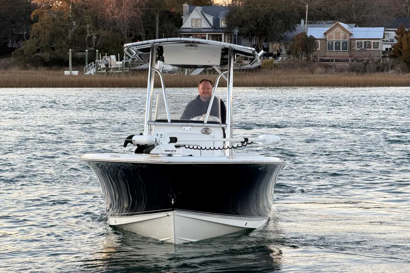Slide: The Image of 2014 Sea Hunt Ultra 211 boat cruising on a scenic waterway. - 7