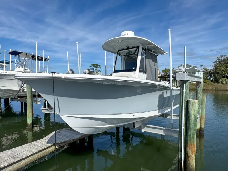Slide: The Image of 2023 Sea Hunt Ultra 239 SE boat on a dock. - 1