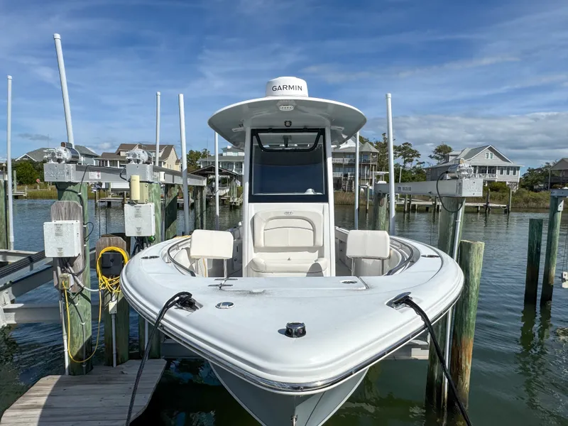 Slide: The Image of 2023 Sea Hunt Ultra 239 SE boat at dock. - 2