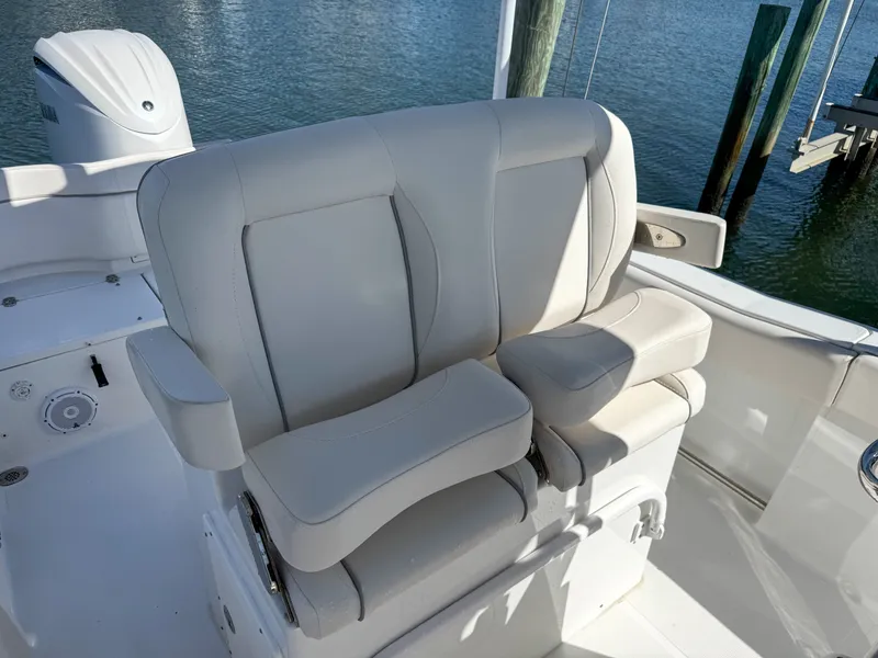 Slide: The Image of 2023 Sea Hunt Ultra 239 SE boat seat by the water. - 20