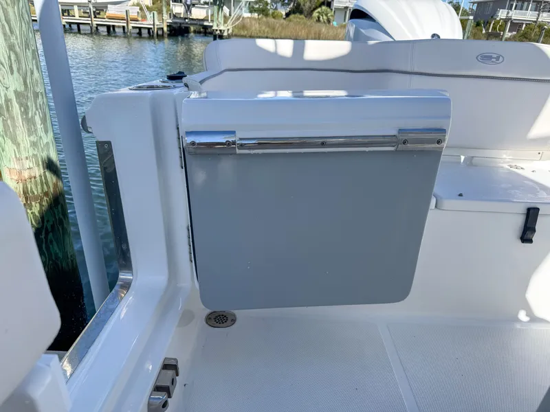 Slide: The Image of 2023 Sea Hunt Ultra 239 SE boat door by the water. - 30