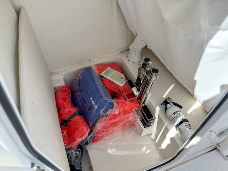 Slide: The Image of Storage compartment in Sea Hunt Ultra 239 SE boat with safety gear. - 35