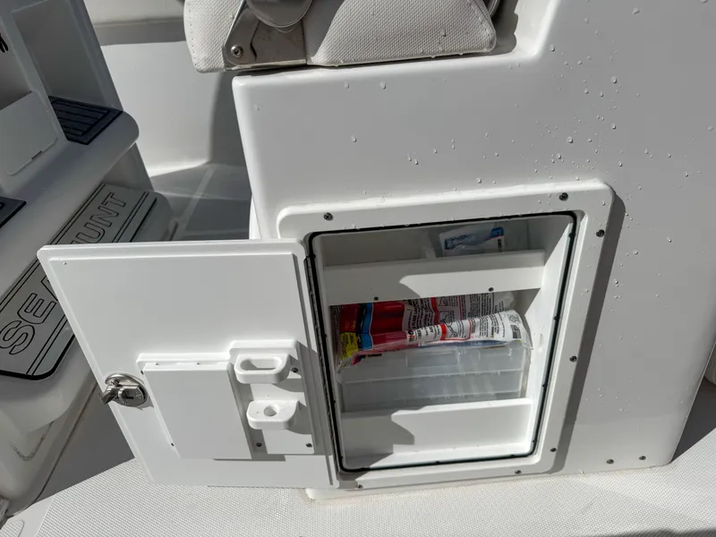 Slide: The Image of Open storage compartment on a 2023 Sea Hunt Ultra 239 SE boat. - 36
