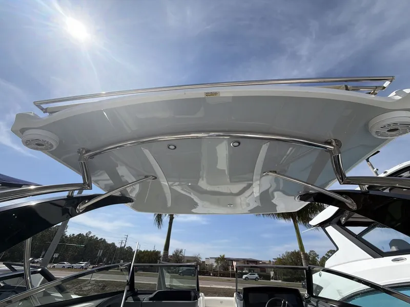 Slide: The Image of Cobalt 30SC 2021 boat with sun canopy and blue sky. - 15