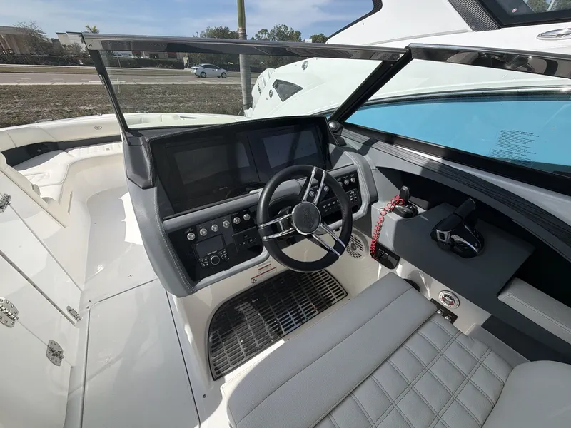 Slide: The Image of Interior view of 2021 Cobalt 30SC boat cockpit with steering and instruments. - 18